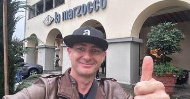 Luke Floyd standing outside the La Marzocco coffee machine factory in Italy.