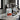 500g bag of Artisti The Fix coffee beans with white and red branding on a concrete kitchen counter near an espresso machine.