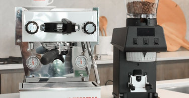 An image showing a white La Marzocco Linea Micra positioned beside a La Marzocco Pico coffee grinder in a modern Australian kitchen setting. 