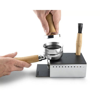 Image showing a Brewspire Eurista Tamping Station being used. The tamp station is available at Artisti Coffee Roasters in Coffs Harbour NSW Australia. 