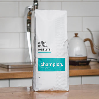 A picture of a 1kg bag of Champion Coffee beans 